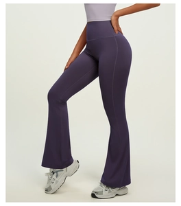 Detail view of high waisted flared yoga pants in dark purple with body contouring fit