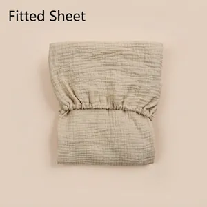 Detail of baby fitted sheet with double-layer cotton gauze texture and elastic band