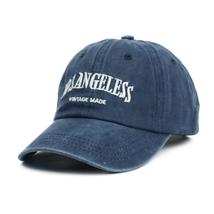 Navy blue washed cotton baseball cap with vintage white embroidery and curved brim