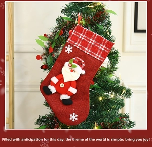 Detail of Christmas stocking with 3D Santa Claus and snowflake on burlap texture