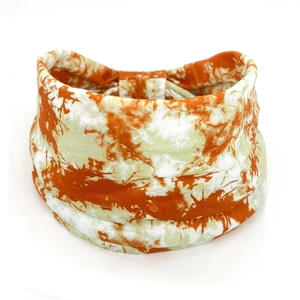 Detailed texture of orange and white paisley pattern on elastic bohemian cotton headband