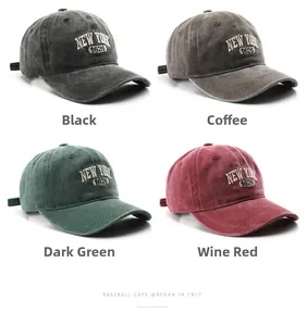 Detail view of retro baseball caps in black, coffee, dark green, and burgundy colors