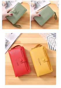 Detailed view of long zip-around wallets in litchi grain faux leather with wrist straps
