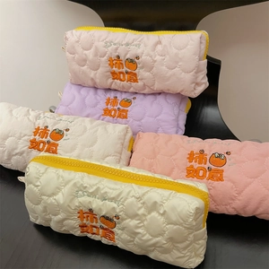 Quilted floral pouches in five colors with persimmon embroidery and yellow zippers