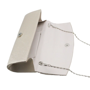 Detail view of champagne satin clutch with pleated fabric and silver chain strap