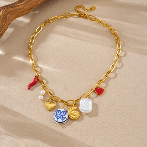 Gold plated link necklace with mixed pendants like red chili, pearl, and floral heart charm