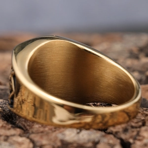 Macro shot of gold mason ring showing polished inner band texture and sleek side profile