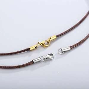 Close-up of brown braided wax cords with gold and silver stainless steel lobster clasps