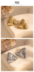 Macro view of geometric triangular earrings with pleated texture in gold and silver