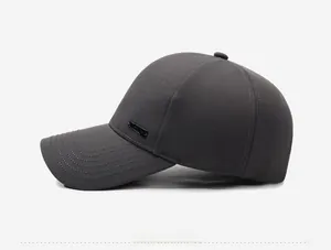 Side view of dark grey baseball cap with structured crown and metal logo detail