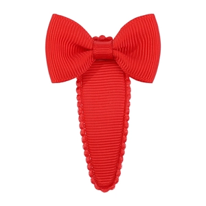 Close-up of a red grosgrain ribbon bow hair clip with a fully covered snap base