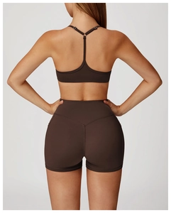 Rear view of brown high-waisted yoga shorts and sports bra with seamless stitching