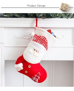 Detail of red knitted Christmas stocking with 3D Santa Claus and rustic wood buttons