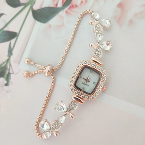 Elegant rose gold square watch with crystal floral accents and adjustable sliding chain