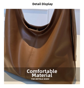 Detailed close-up of brown PU leather texture and decorative stitching on tote bag
