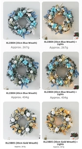 Detail of Christmas wreath variants in blue and gold with LED lights and snow-flocked pine needles