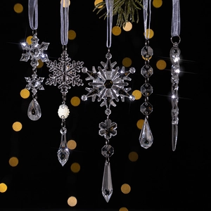 Detailed view of clear acrylic snowflake and icicle ornaments with elegant silver ribbons