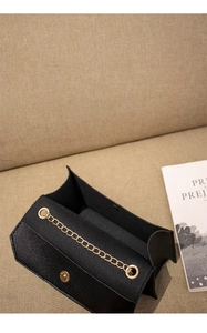 Top view of mini crossbody bag showing golden chain strap and magnetic flap closure