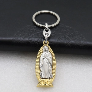 Macro detail of bimetal Virgin of Guadalupe religious keychain on black leather