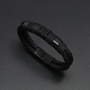 Detail view of double-layered black braided leather bracelet with magnetic metal clasp