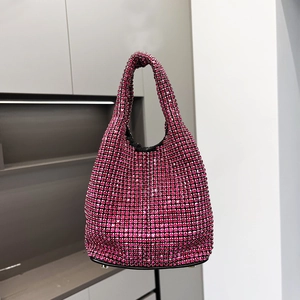 Detailed macro view of the rose red rhinestone bucket bag featuring protective metal feet