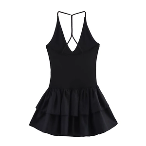 Close-up of black backless halter dress showing crisscross straps and ruffled hem detail