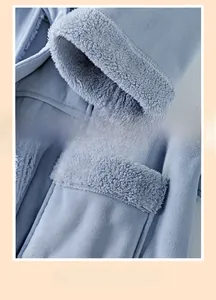 Detail of blue plush robe showing sleeve tape trim and exquisite stitched pocket edges