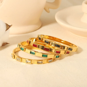 Luxe set of four gold-plated stainless steel bangles with vibrant zircon gemstones