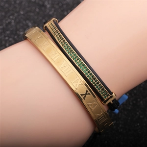 Close-up of gold Roman numeral cuff bracelet and green zircon woven rope set
