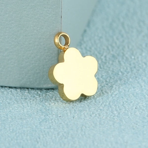 Minimalist gold flower pendant in polished stainless steel with smooth glossy finish