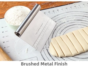Detail of stainless steel dough scraper with dual metric and imperial measurement scales