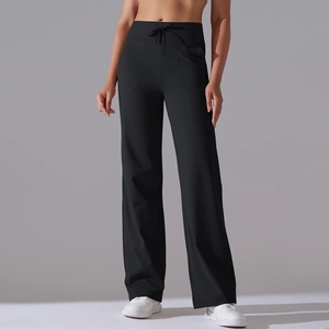Detail of high waisted wide leg yoga pants featuring drawstring waist and curved side pockets