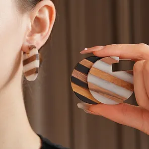 Geometric round wood and resin drop earrings with striped pattern and silver needles