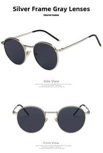 Detail view of retro silver round sunglasses with grey lenses and black ear tips