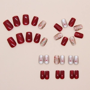 Detailed view of cat-eye red press-on nails with 3D bow designs and colorful glitter