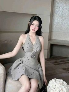 Close-up of grey halter dress featuring delicate 3D floral patterns and waist detail