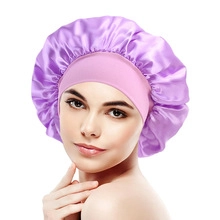Detail of a purple satin sleeping cap with wide elastic band worn by a professional model