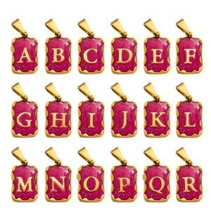 Gold stainless steel alphabet pendants with pink enamel inlay in a grid display