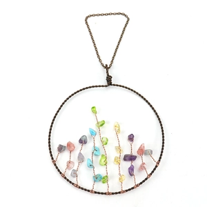 Close-up of tree of life wall hanging with colorful crystals and woven copper wire detail