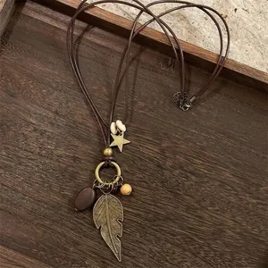 Detailed close-up of retro ethnic necklace with wooden beads and bronze leaf charms