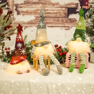Three glowing LED Christmas gnomes with knitted hats in red, grey, and green colors