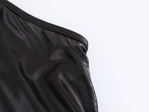 Detailed macro view of black satin fabric with smooth glossy finish and high reflection