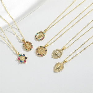 Golden religious pendant necklace collection featuring colorful zircons on white silk
