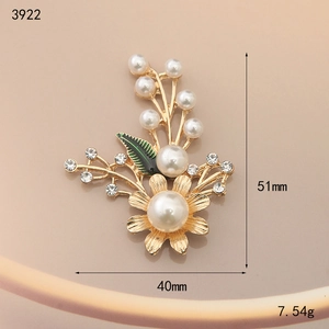 Golden flower and leaf brooch with green enamel, white pearls and sparkling crystals