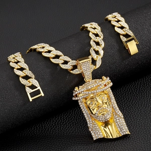Detailed view of hip hop Jesus head pendant with sparkling rhinestones in gold finish