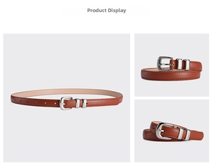 Detail view of a slim caramel leather belt with a round silver buckle and five adjustment holes