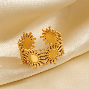 18K gold plated stainless steel sunburst ring on elegant cream satin fabric