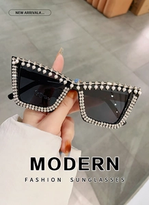Detail of square oversized sunglasses with silver rhinestones and white pearls inlay