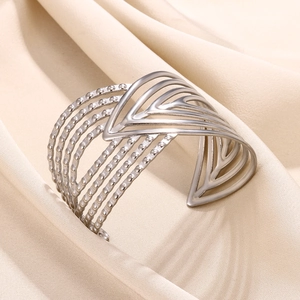 Detail of silver layered geometric V-shape open cuff bracelet with dot texture on silk