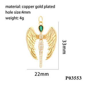Macro shot of 18K gold plated angel pendant with green gem and zircon inlay details